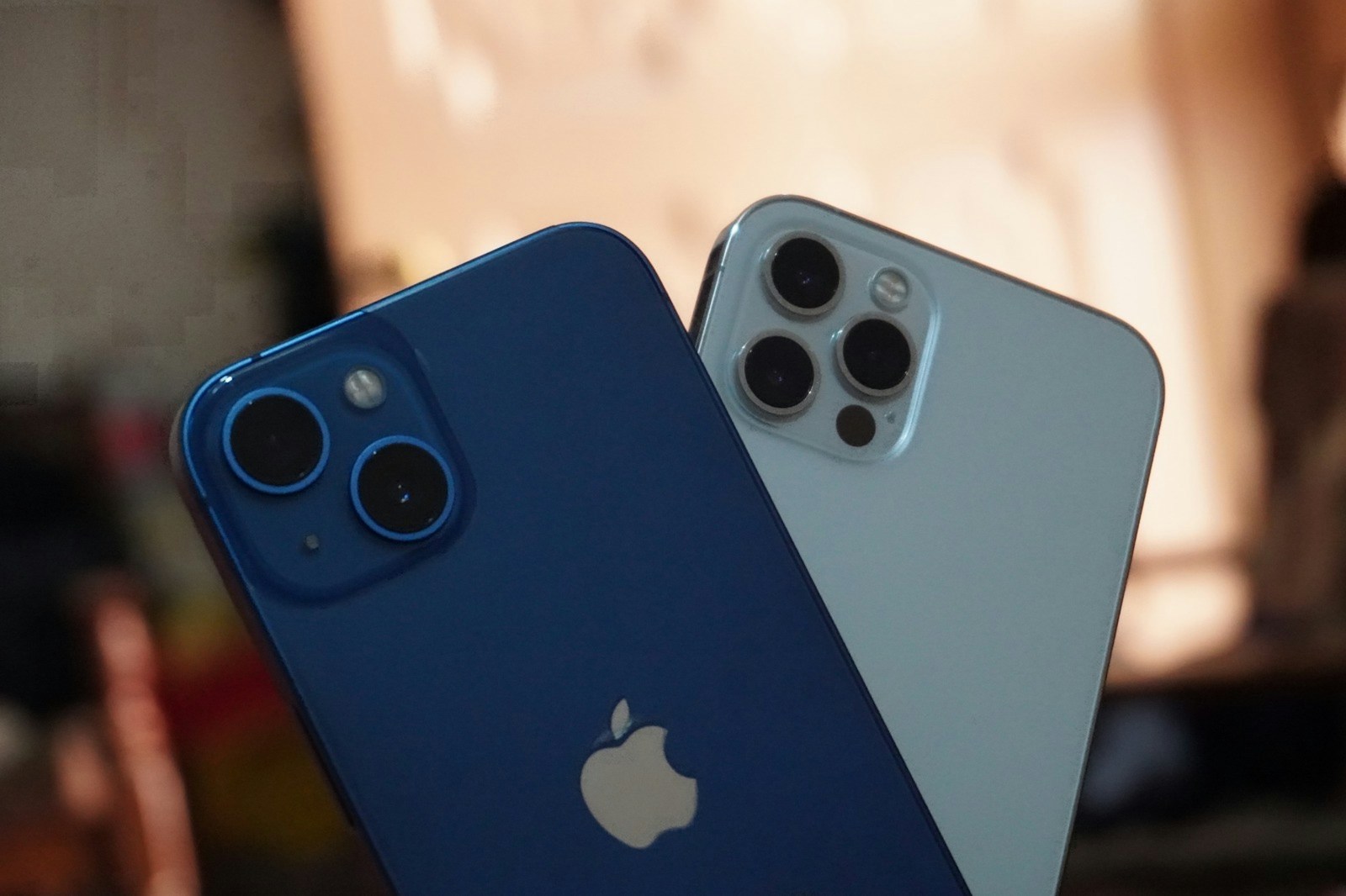two blue and white iphones sitting next to each other